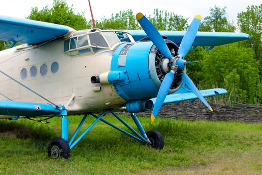 Old retro airplane on green grass field