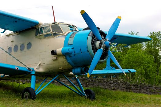Old retro airplane on green grass field