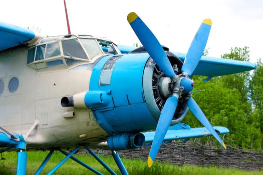 Old retro airplane on green grass field
