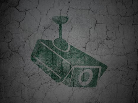 Security concept: Green Cctv Camera on grunge textured concrete wall background