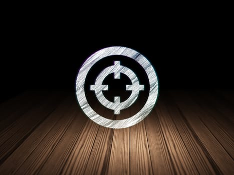 Business concept: Glowing Target icon in grunge dark room with Wooden Floor, black background