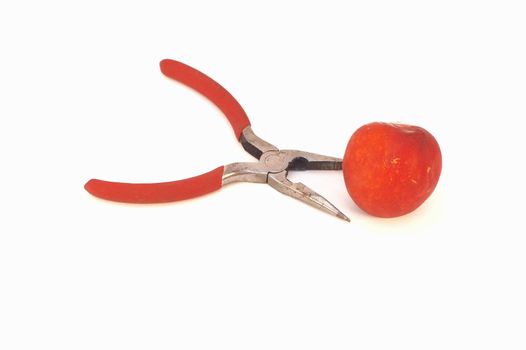 pliers and a nectarine, isolated
