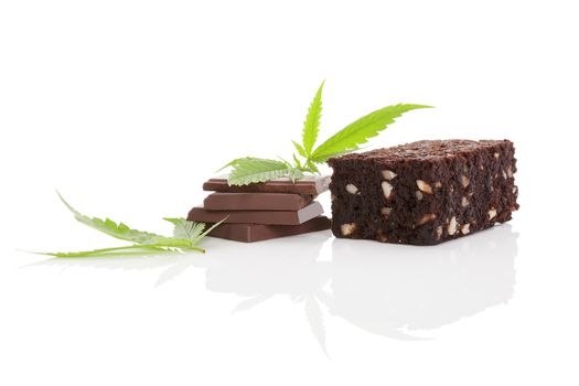 Cannabis chocolate and cannabis brownie with ganja leaf isolated on white background. 
