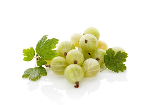 Green gooseberries with green leaves isolated on white background. Healthy summer fruit eating. 