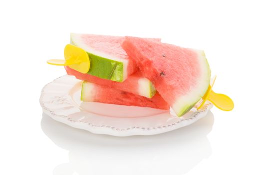 Fresh ripe water melon as ice pop on plate isolated on white background. 