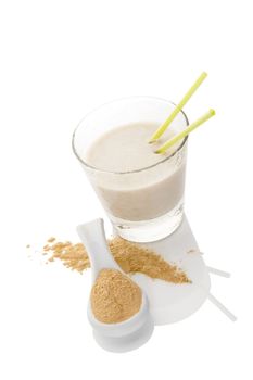 Maca powder on spoon and maca milkshake in glass isolated on white background. Natural alternative medicine.