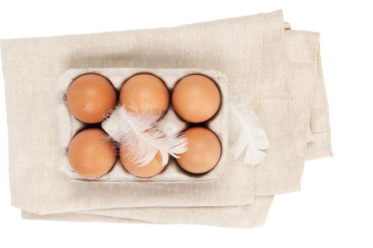 Organic chicken eggs in paper box isolated on white background, top view.