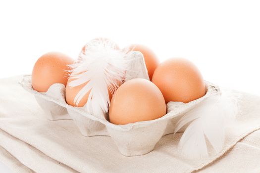 Organic chicken eggs in paper box isolated on white background.
