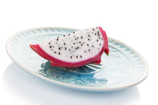 Delicious ripe dragon fruit piece on plate isolated on white background. Tropical fruit, pitaya concept. Healthy eating. 