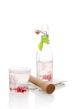 Delicious pomegranate lemonade with lime isolated on white background. Culinary fresh summer drink.