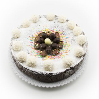 Easter cake with ricotta and chocolate decorated with chocolate eggs and powdered sugar