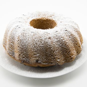 classic italian cake with icing sugar and hole in the center