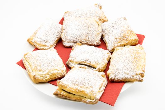 handmade biscuits of puff pastry stuffed with chocolate and covered with powdered sugar