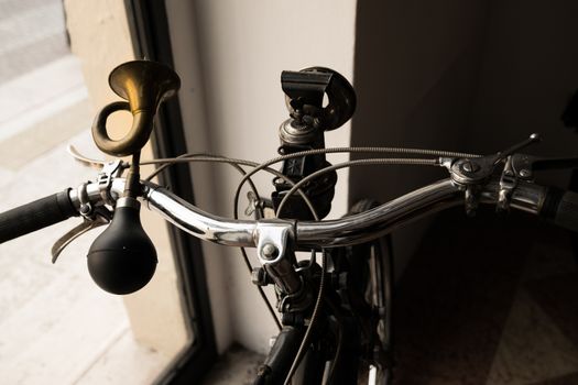 handlebar with horn like a trumpet and acetylene headlight of a vintage moped