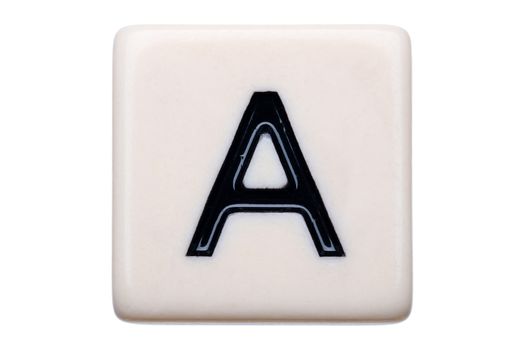 A macro shot of a game tile with the letter A on it on a white background.