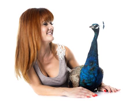 young woman and peacock in front of white background