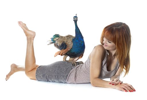 young woman and peacock in front of white background