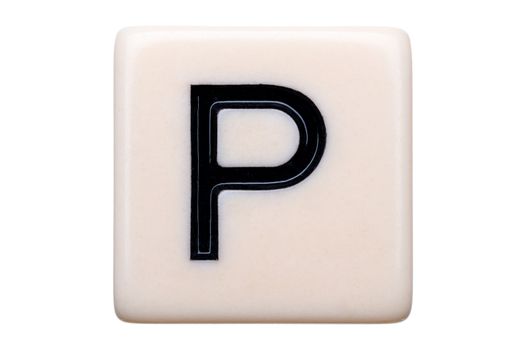 A macro shot of a game tile with the letter P on it on a white background.