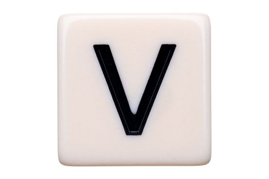 A macro shot of a game tile with the letter V on it on a white background.