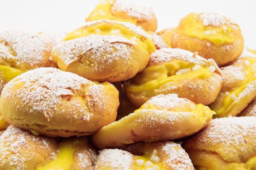 handmade cream puffs with icing sugar