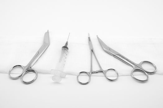 surgical composition with forceps, scissors and syringe