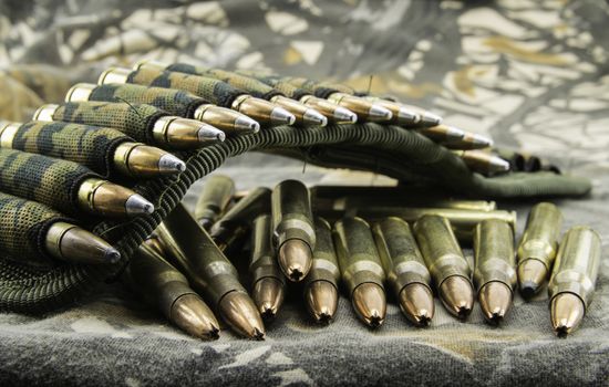 camouflage ammunition belt for rifle  on camouflage background