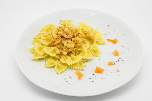 italian traditional pasta called butterflies with shrimp salmon and basil