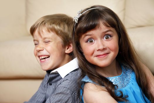 Brother and sister at home smiling