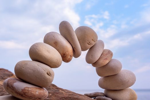 Pebbles in the form of a arch on the coast