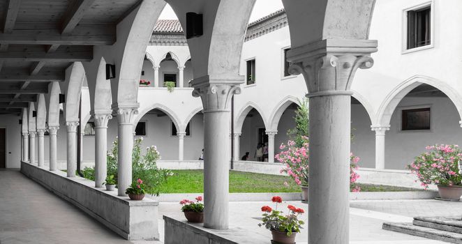 rectangular cloister with Gothic arches and marble columns.
