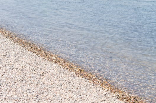 Beautiful waterside scenery with little stones on a river.