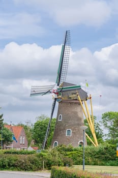 Historic old windmill in the province of Zeeland, Netherlands against blue sky.