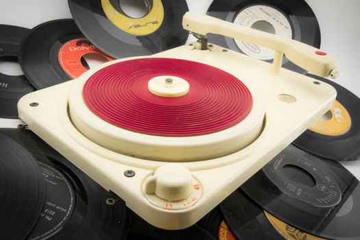 composition with red vintage record player and old records