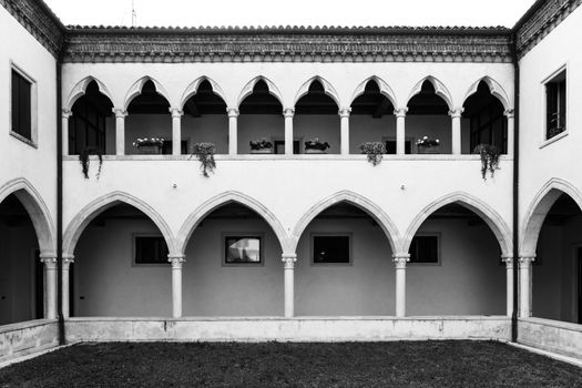 rectangular cloister with Gothic arches and marble columns. On the first floor a lovely loggia with gothic arches trefoil.