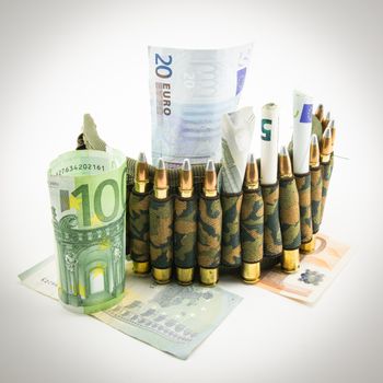 composition with bullets and banknotes on white background