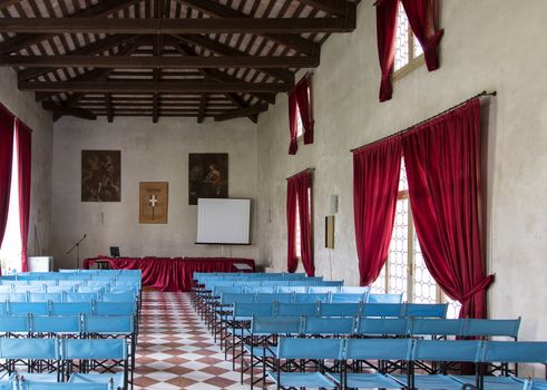 VICENZA, ITALY - MAY 13: Conference hall with canvas blue chairs and red curtains, inside villa Cordellina Lombardi in Vicenza on Wednesday, May 13, 2015.
