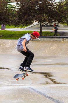 CALGARY, CANADA - JUN 21, 2015: Athletes have a friendly skateboard competition in Calgary. California law requires anyone under the age of 18 to wear a helmet while riding a skateboard.