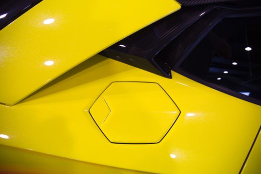 hexagonal fuel cap of a yellow sportscar