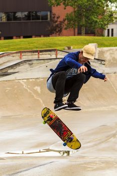 CALGARY, CANADA - JUN 21, 2015: Athletes have a friendly skateboard competition in Calgary. California law requires anyone under the age of 18 to wear a helmet while riding a skateboard.