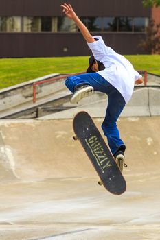 CALGARY, CANADA - JUN 21, 2015: Athletes have a friendly skateboard competition in Calgary. California law requires anyone under the age of 18 to wear a helmet while riding a skateboard.