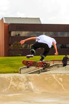 CALGARY, CANADA - JUN 21, 2015: Athletes have a friendly skateboard competition in Calgary. California law requires anyone under the age of 18 to wear a helmet while riding a skateboard.