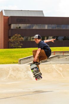 CALGARY, CANADA - JUN 21, 2015: Athletes have a friendly skateboard competition in Calgary. California law requires anyone under the age of 18 to wear a helmet while riding a skateboard.