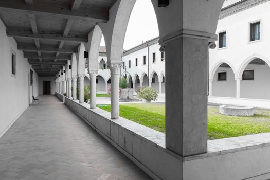 rectangular cloister with Gothic arches and marble columns.