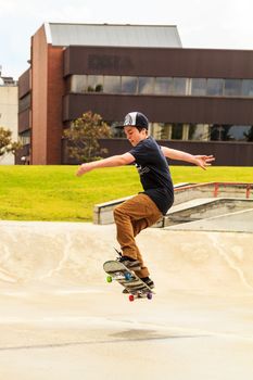 CALGARY, CANADA - JUN 21, 2015: Athletes have a friendly skateboard competition in Calgary. California law requires anyone under the age of 18 to wear a helmet while riding a skateboard.