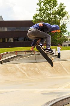 CALGARY, CANADA - JUN 21, 2015: Athletes have a friendly skateboard competition in Calgary. California law requires anyone under the age of 18 to wear a helmet while riding a skateboard.