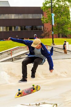 CALGARY, CANADA - JUN 21, 2015: Athletes have a friendly skateboard competition in Calgary. California law requires anyone under the age of 18 to wear a helmet while riding a skateboard.