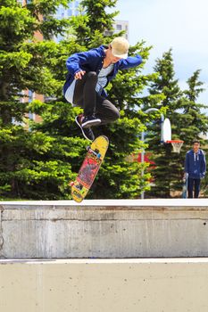 CALGARY, CANADA - JUN 21, 2015: Athletes have a friendly skateboard competition in Calgary. California law requires anyone under the age of 18 to wear a helmet while riding a skateboard.