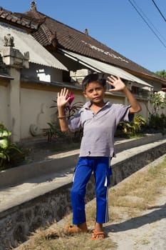 BALI, NUSA PENIDA ISLAND, INDONESIA - JULY 28.2015: Unidentified Indonesian boy on Toyapakeh street. Nusa Penida July 27. 2015 Indonesia
