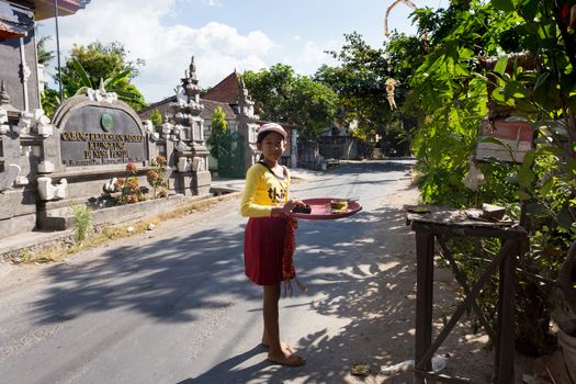 BALI, NUSA PENIDA ISLAND, INDONESIA - JULY 28.2015: Unidentified balinese indonesian girl bring offerings of fruits and gifts to the home temple. Nusa Penida July 27. 2015 Indonesia