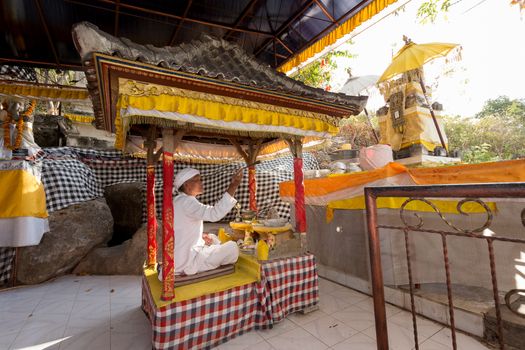 BALI, NUSA PENIDA ISLAND, INDONESIA - JULY 28.2015: Unidentified Balinese monk at praying ceremony in Goa Giri Putri temple. Nusa Penida July 27. 2015 Indonesia